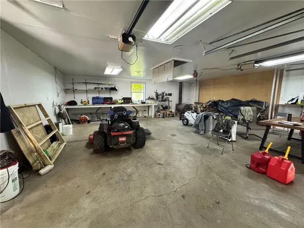 a room with lots of white furniture and clutter