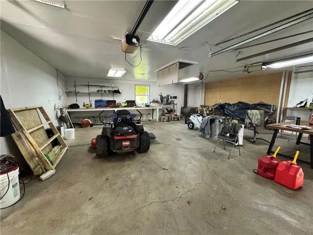 a room with lots of white furniture and clutter