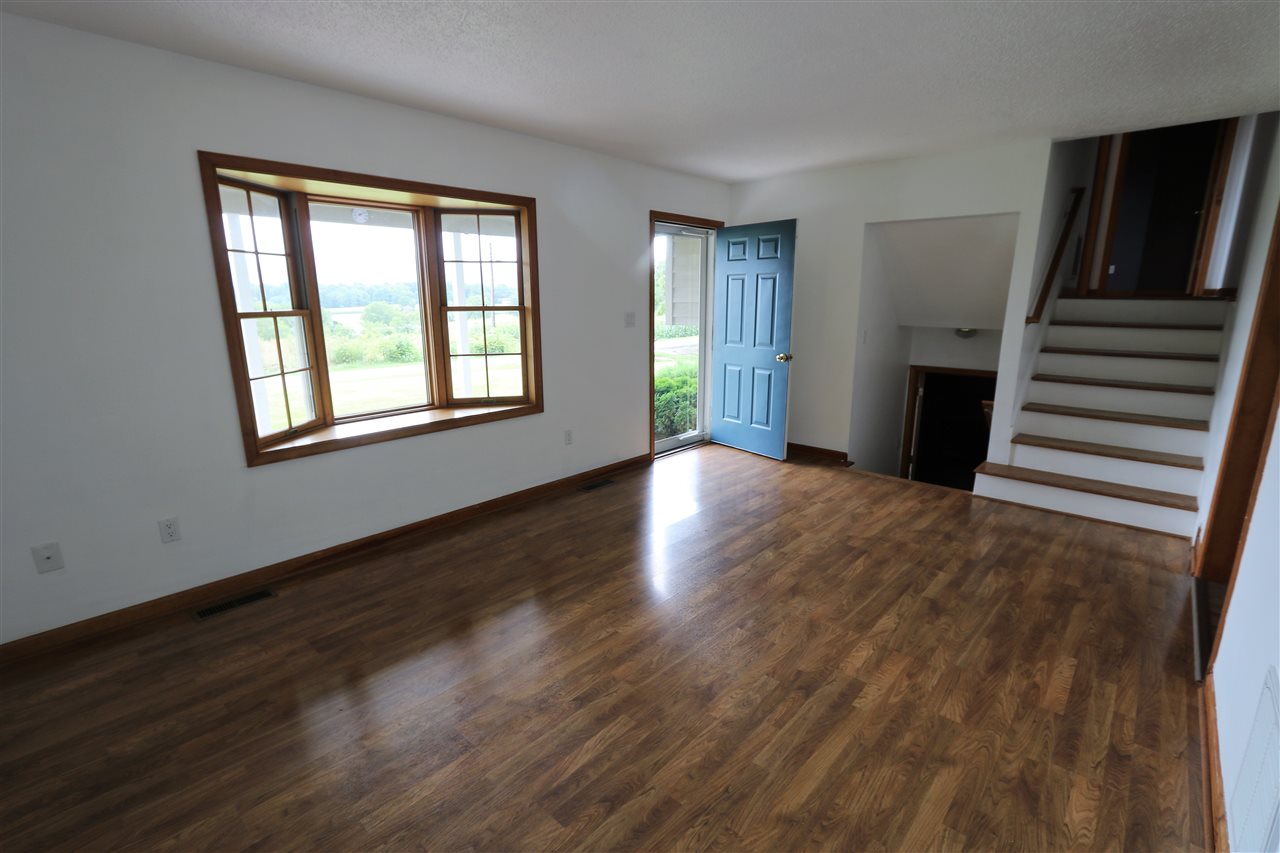 1067 Madrid Road Waynesboro, VA 22980 - Photo 12 of 48 a view of an empty room with wooden floor and a window