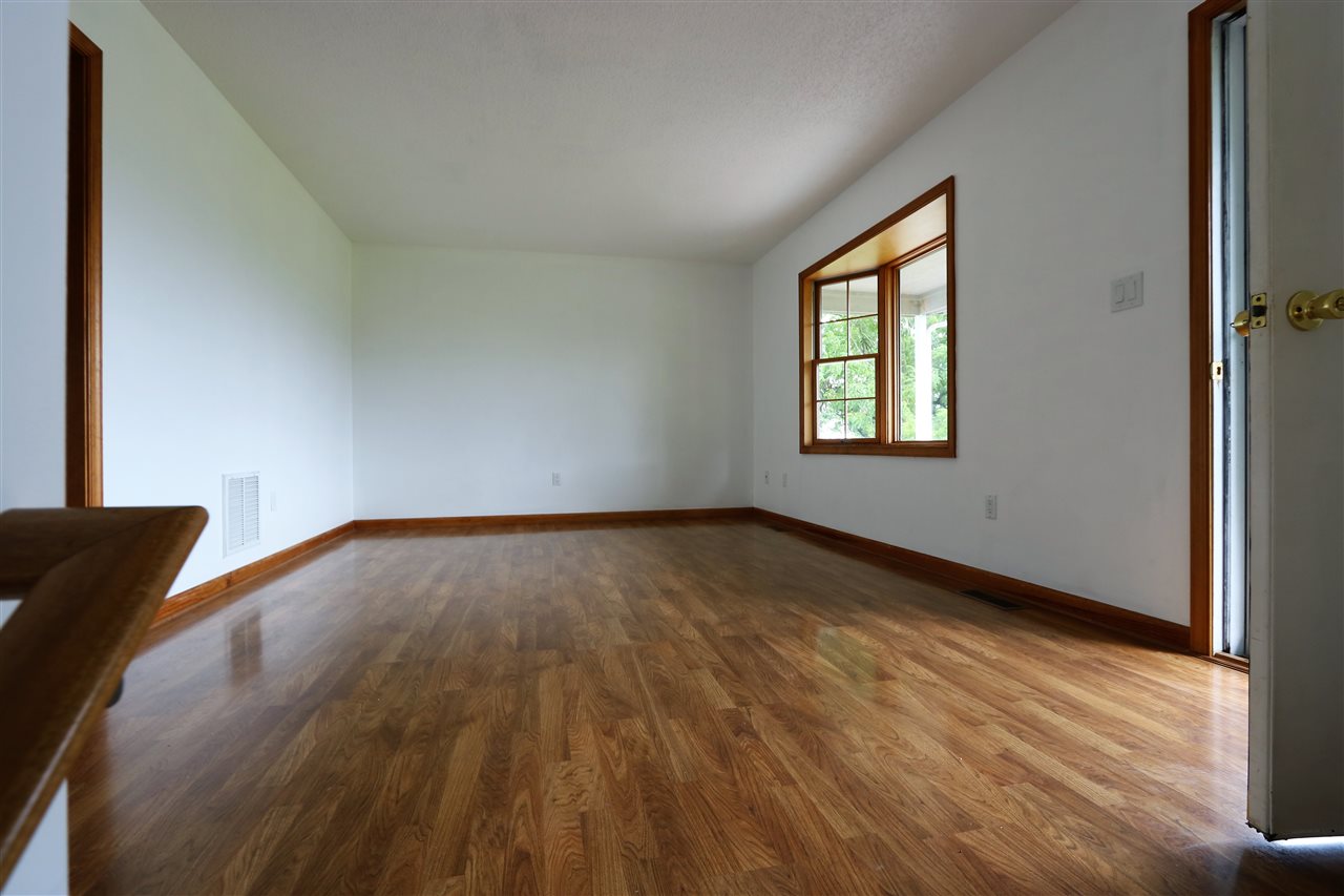 1067 Madrid Road Waynesboro, VA 22980 - Photo 14 of 48 a view of an empty room with wooden floor and a window
