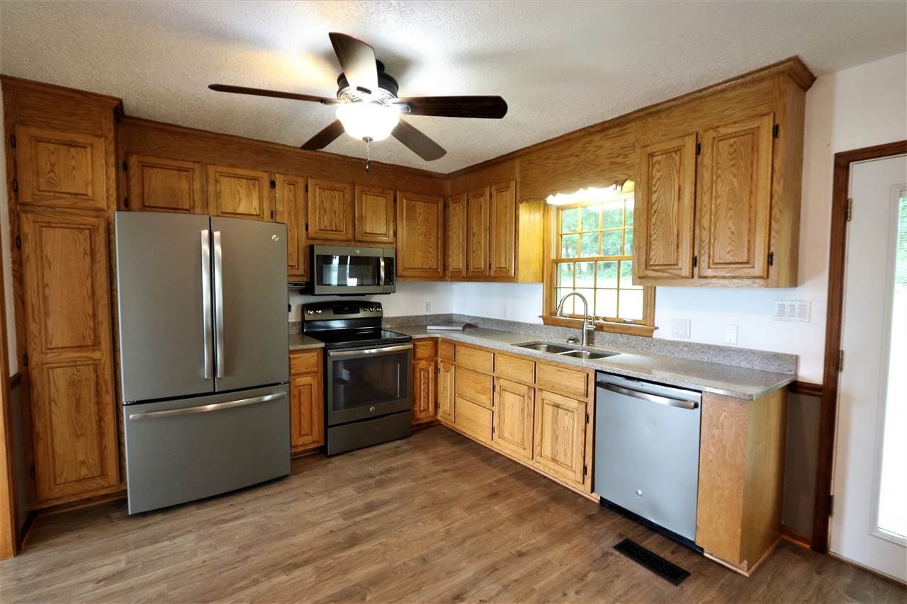 1067 Madrid Road Waynesboro, VA 22980 - Photo 15 of 48 a kitchen with granite countertop stainless steel appliances a refrigerator cabinets and a window