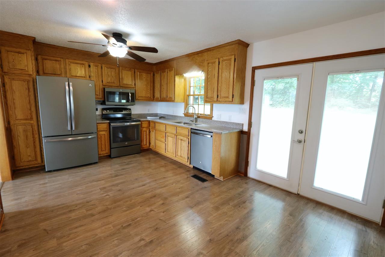 1067 Madrid Road Waynesboro, VA 22980 - Photo 19 of 48 a kitchen with stainless steel appliances granite countertop a refrigerator a oven a sink dishwasher and a refrigerator with wooden floor