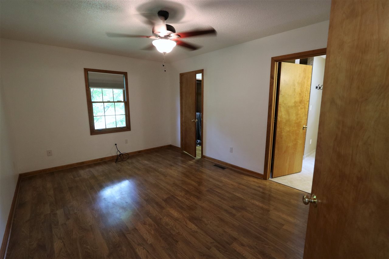 1067 Madrid Road Waynesboro, VA 22980 - Photo 23 of 48 a view of an empty room with wooden floor and a window