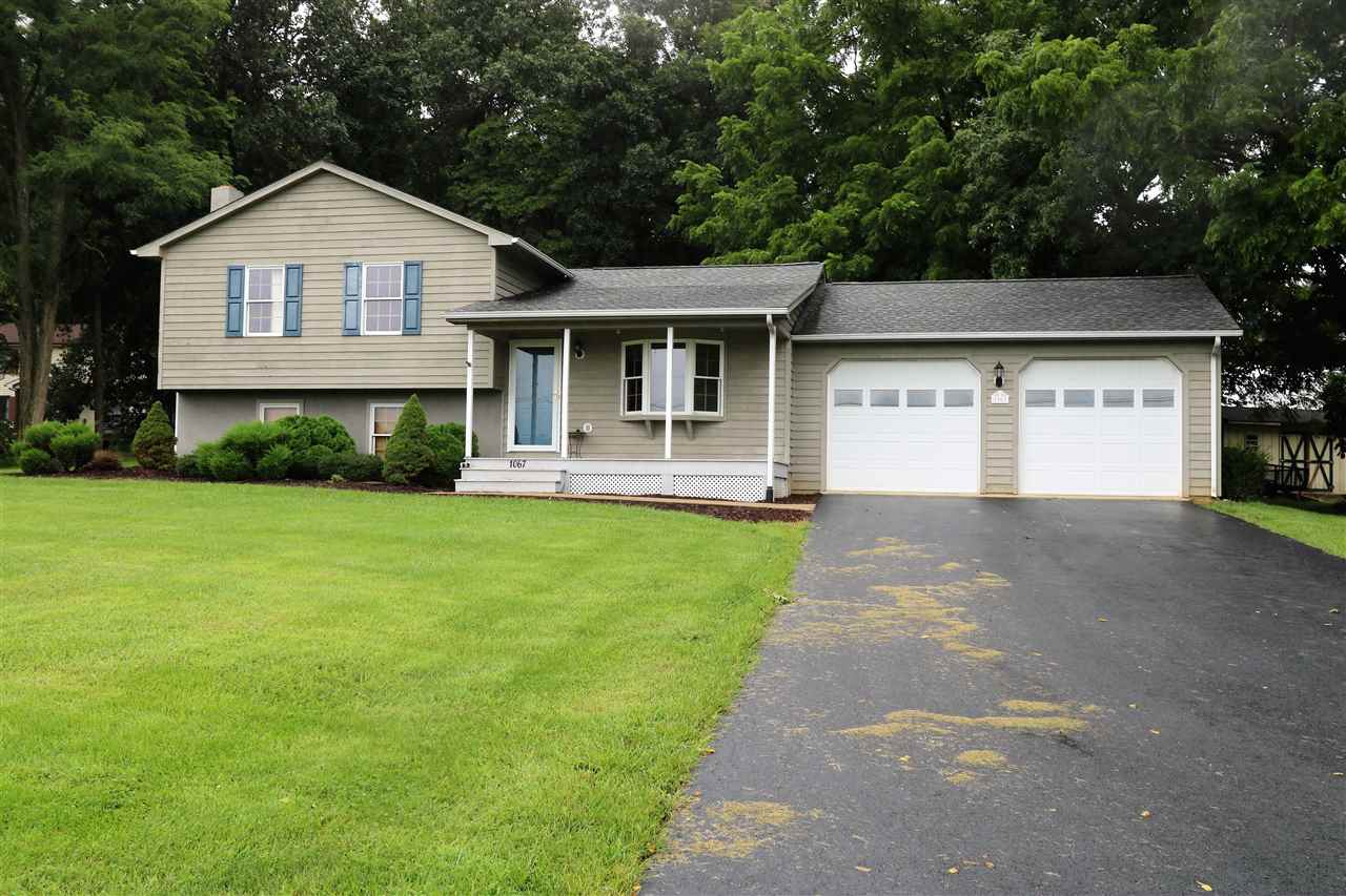 1067 Madrid Road Waynesboro, VA 22980 - Photo 10 of 48 a front view of a house with a yard and garage