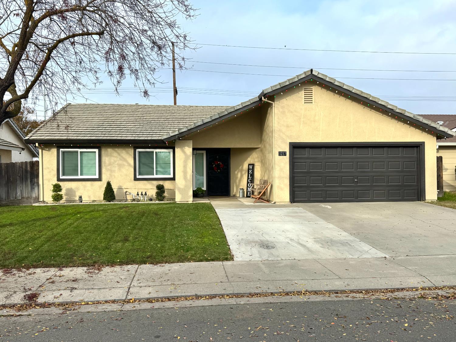 3217 Matterhorn Way Ceres, CA 95307 - Photo 1 of 1 a front view of a house with a yard and garage