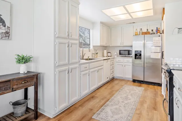a kitchen with cabinets and appliances