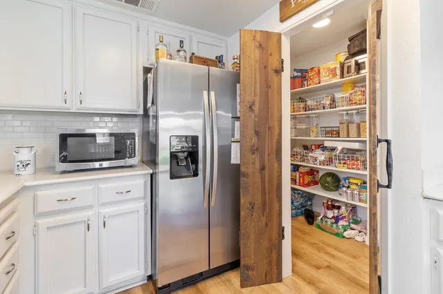 a kitchen with stainless steel appliances a refrigerator and cabinets