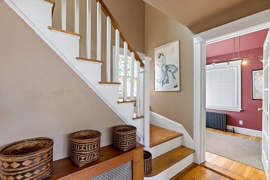 10 Bowker Street Lexington, MA 02421 - Photo 13 of 24 a view of staircase with furniture and a kitchen view