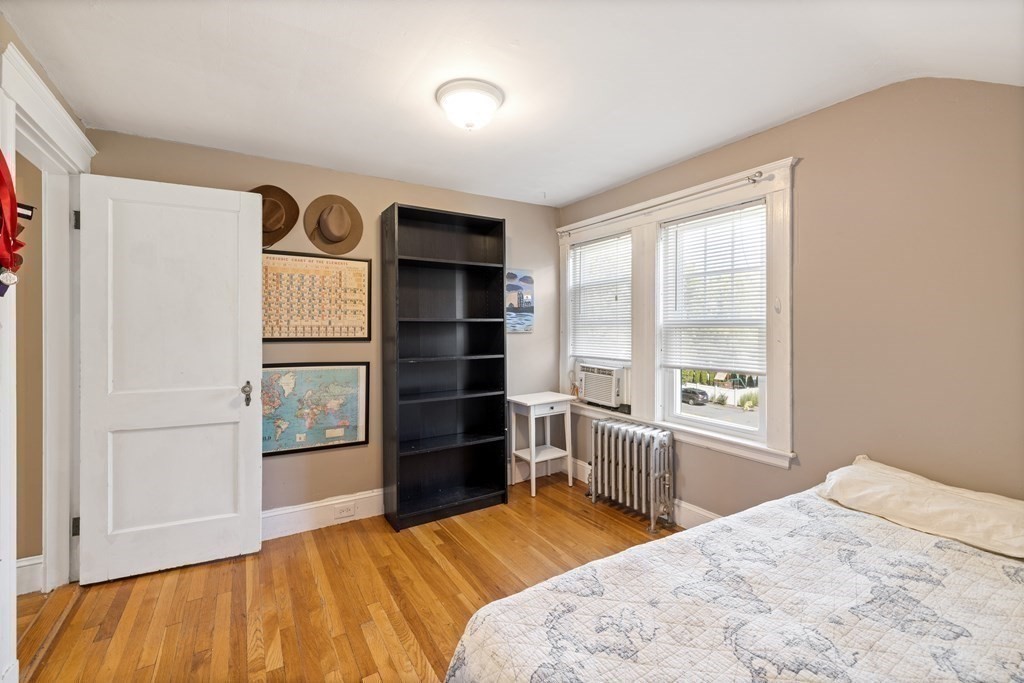 10 Bowker Street Lexington, MA 02421 - Photo 18 of 24 a bedroom with a bed and a window with chair