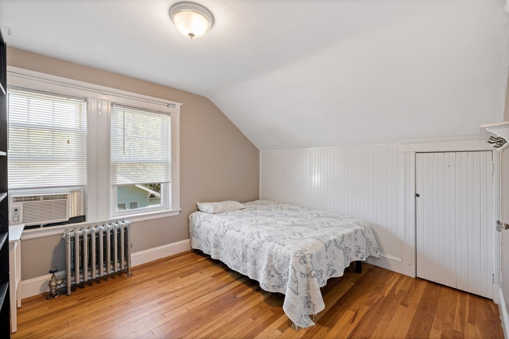 10 Bowker Street Lexington, MA 02421 - Photo 19 of 24 a bedroom with a bed and wooden floor