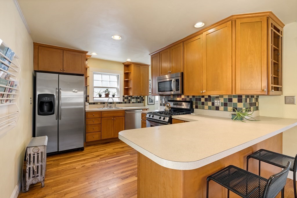 10 Bowker Street Lexington, MA 02421 - Photo 6 of 24 a kitchen with a sink a stove and refrigerator