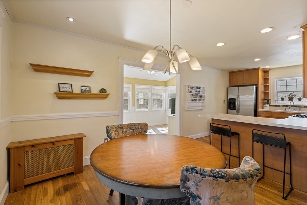 10 Bowker Street Lexington, MA 02421 - Photo 9 of 24 a dining room filled chandelier and wooden floor