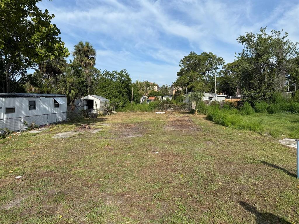 5619 Leisure Lane New Port Richey, FL 34652 - Photo 3 of 4 a view of backyard with outdoor seating and green space