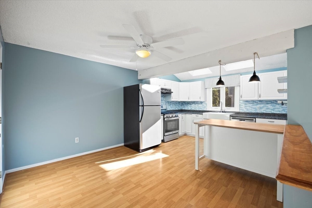 6 Robin Circle, Unit 1 Norton, MA 02766 - Photo 13 of 38 a large kitchen with stainless steel appliances a large counter top a stove a sink dishwasher and a refrigerator