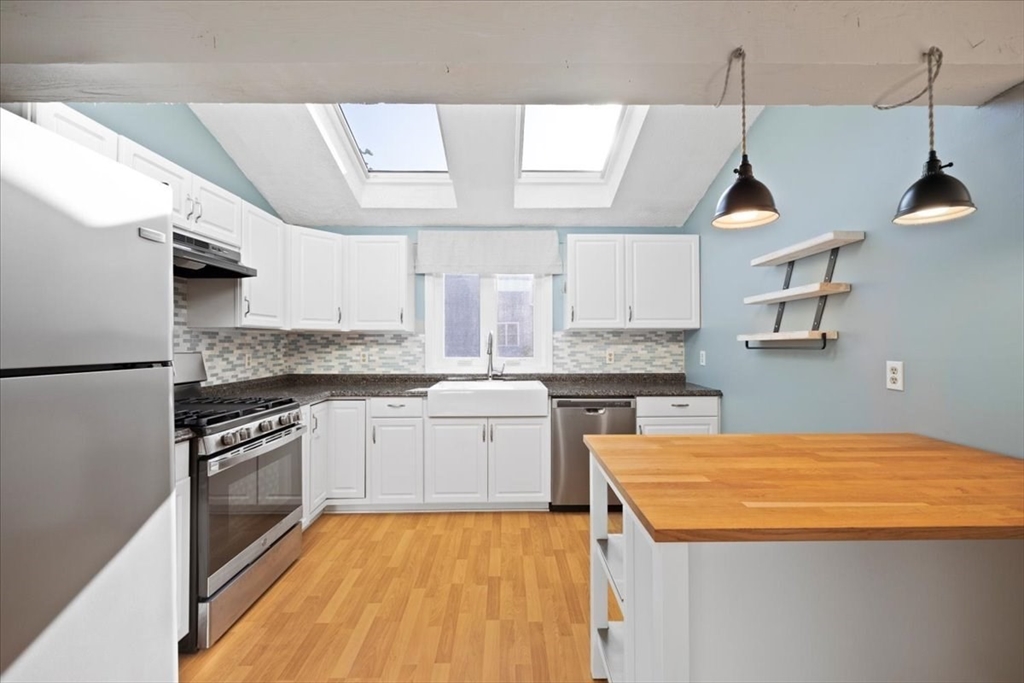 6 Robin Circle, Unit 1 Norton, MA 02766 - Photo 19 of 38 a kitchen with stainless steel appliances granite countertop a sink and stove top oven