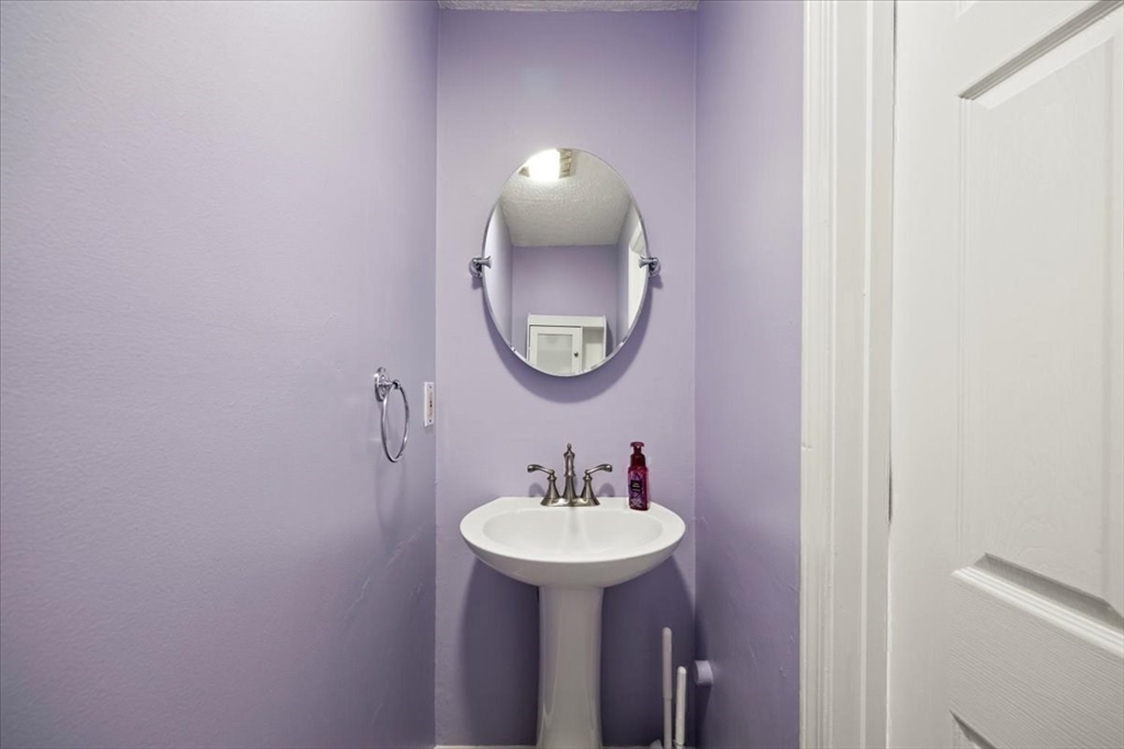 6 Robin Circle, Unit 1 Norton, MA 02766 - Photo 20 of 38 a bathroom with a sink and a mirror