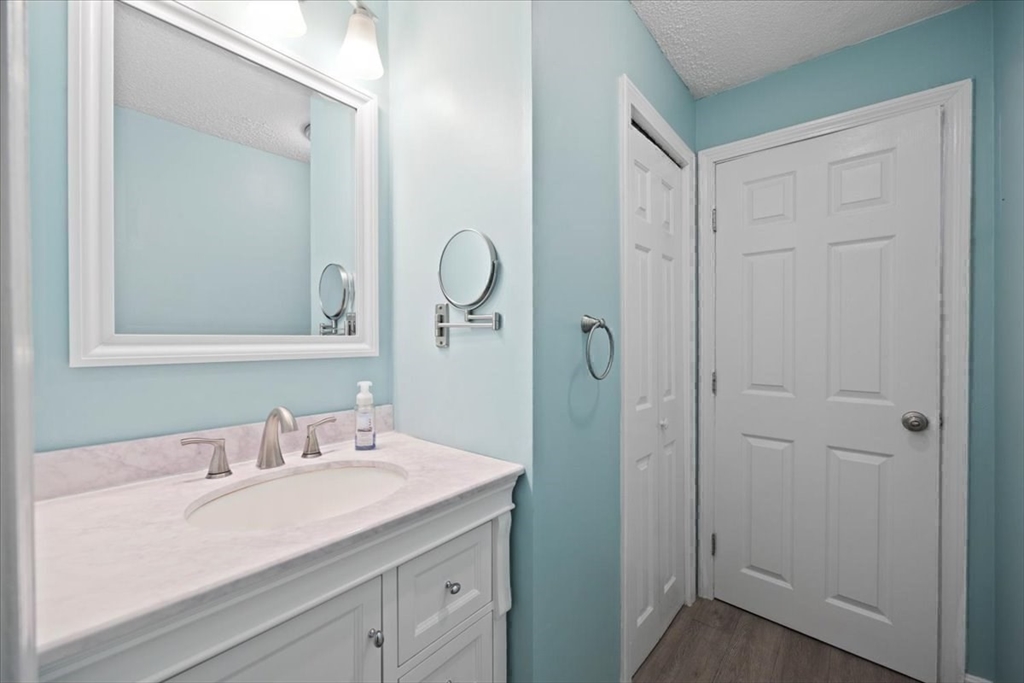 6 Robin Circle, Unit 1 Norton, MA 02766 - Photo 25 of 38 a bathroom with a sink and a mirror