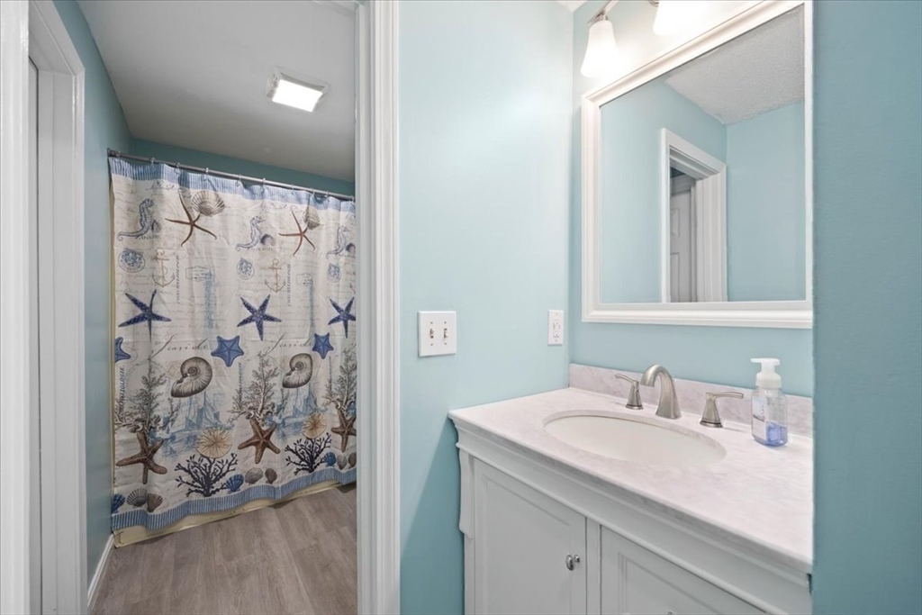 6 Robin Circle, Unit 1 Norton, MA 02766 - Photo 26 of 38 a bathroom with a sink and a mirror