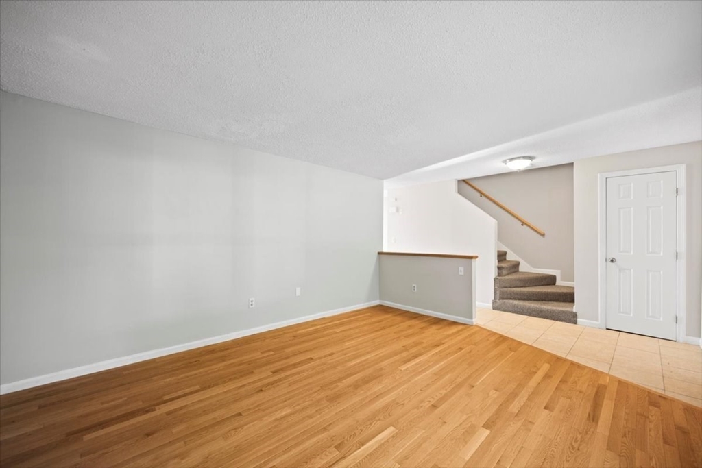 6 Robin Circle, Unit 1 Norton, MA 02766 - Photo 3 of 38 a view of empty room with wooden floor