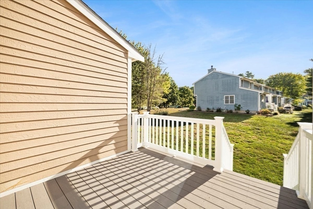6 Robin Circle, Unit 1 Norton, MA 02766 - Photo 35 of 38 a view of a balcony with wooden floor and fence