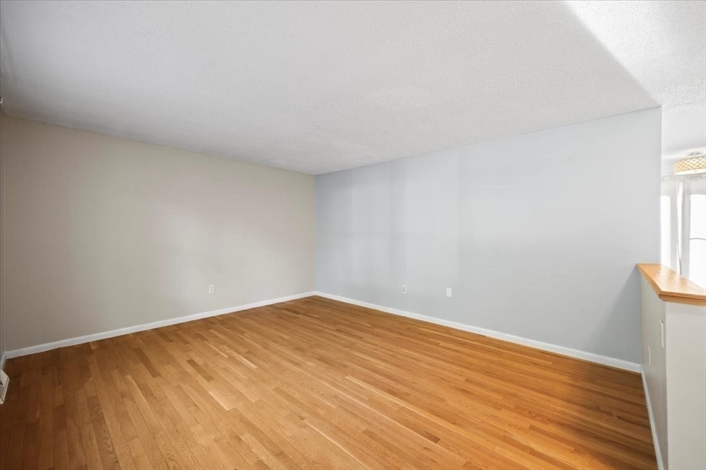 6 Robin Circle, Unit 1 Norton, MA 02766 - Photo 5 of 38 a view of empty room with wooden floor