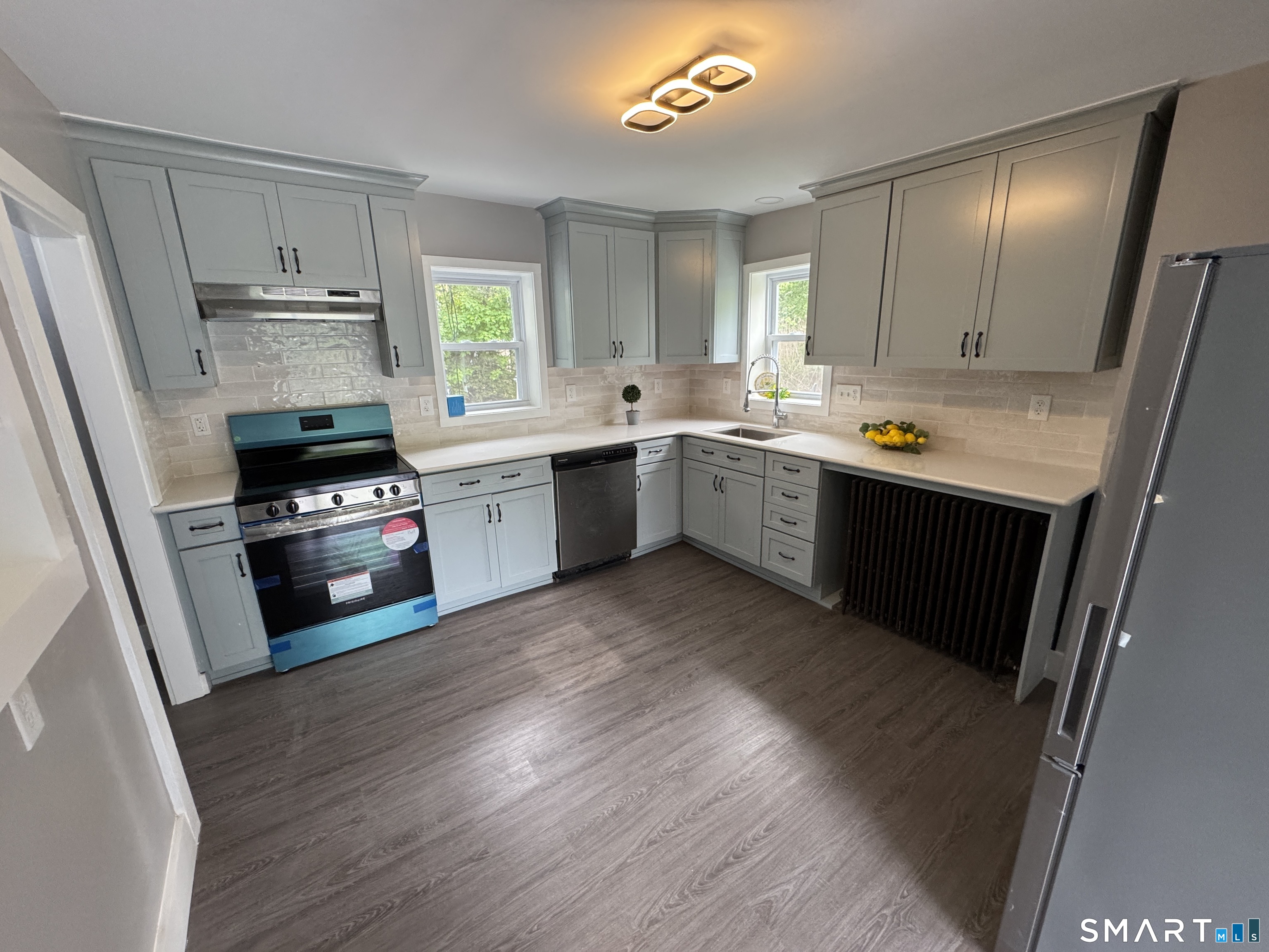10 Center Street Windsor Locks, CT 06096 - Photo 3 of 25 a kitchen with a sink a stove a refrigerator and cabinets