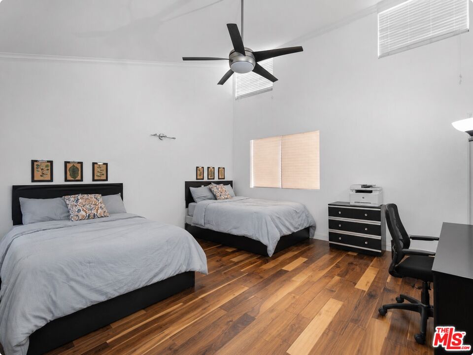 1114 Las Riendas Way Pasadena, CA 91107 - Photo 11 of 20 a bedroom with a bed and a chandelier