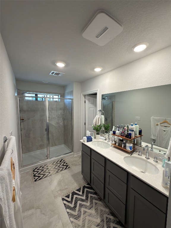 132 Small Seed Buda, TX 78610 - Photo 11 of 18 a bathroom with a sink a mirror and a shower