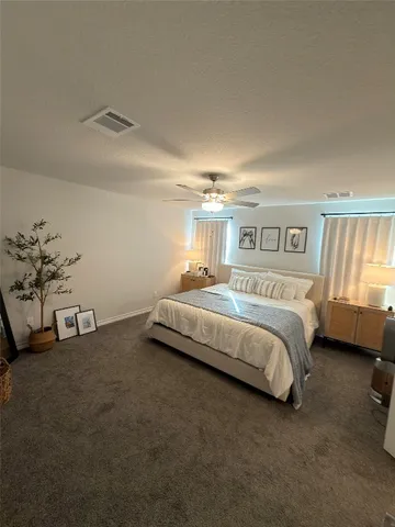 a bed sitting in a bedroom next to a window