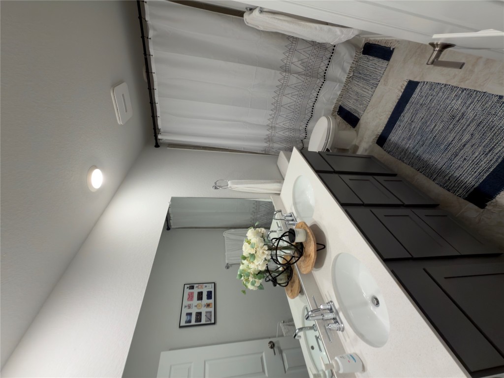 132 Small Seed Buda, TX 78610 - Photo 15 of 18 a bathroom with a sink and a mirror