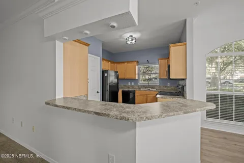 a kitchen with stainless steel appliances granite countertop a stove microwave and sink