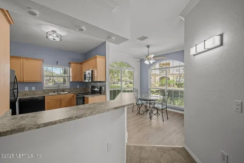 a kitchen with a stove a sink and a microwave
