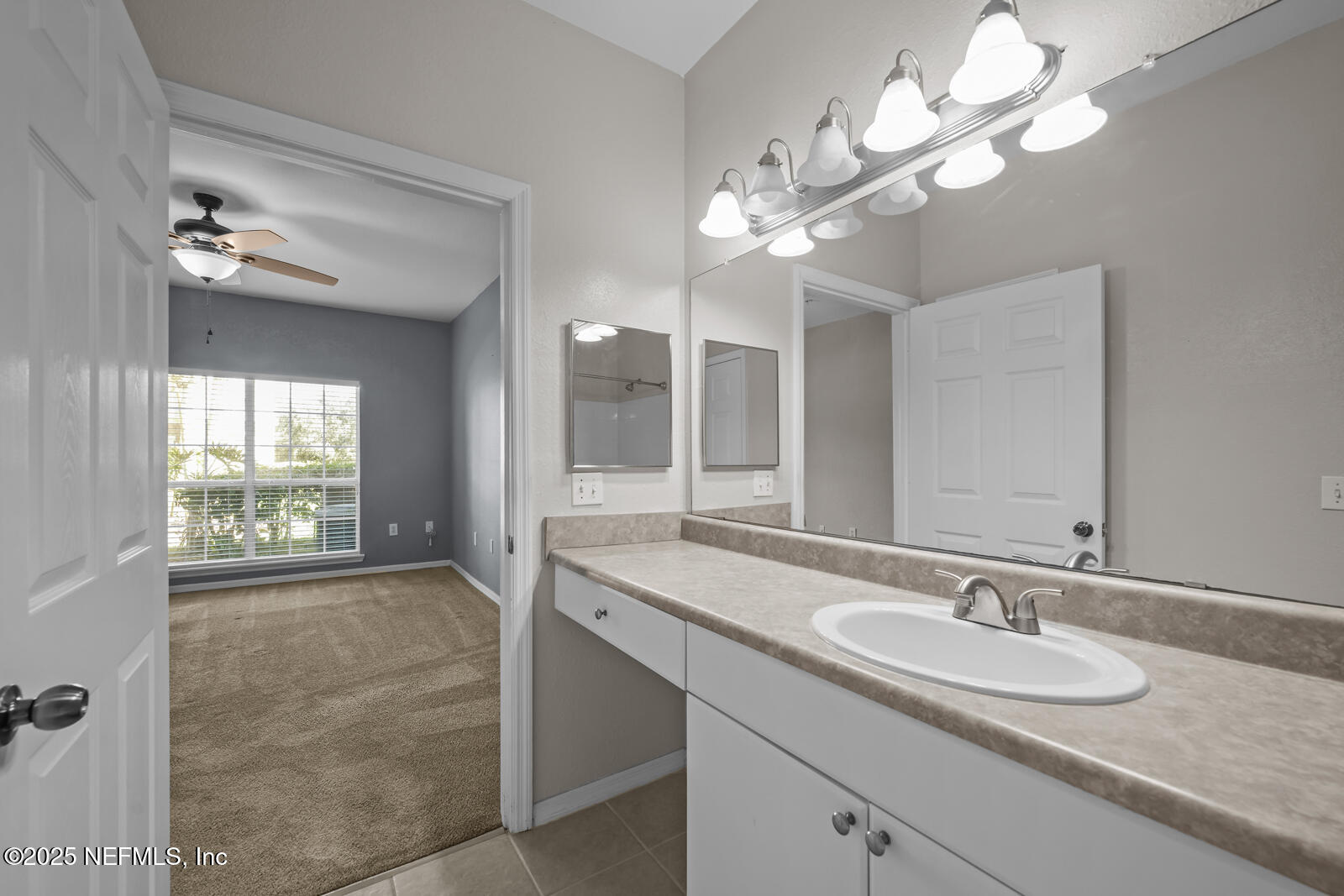 10961 Burnt Mill Road, Unit 1217 Jacksonville, FL 32256 - Photo 15 of 59 a bathroom with a granite countertop sink a light fixture and a mirror