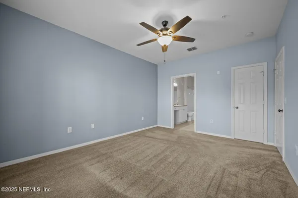 a bed room with a bed and a chair