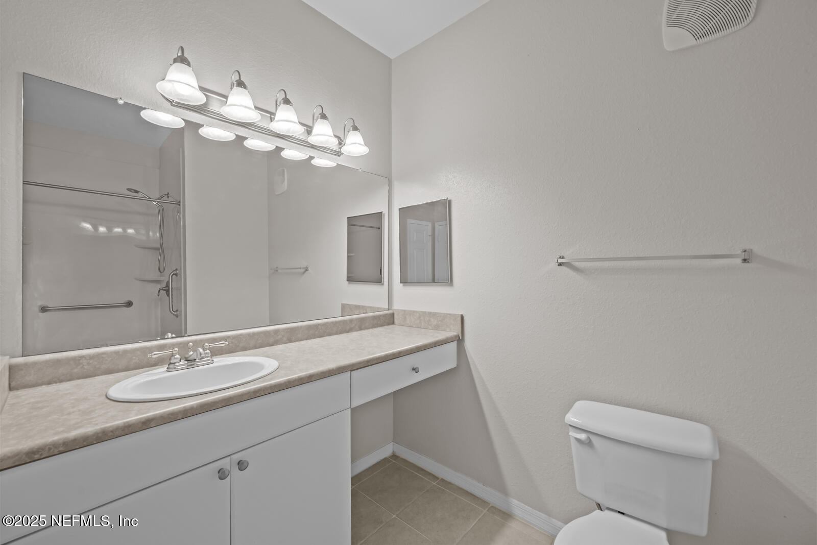10961 Burnt Mill Road, Unit 1217 Jacksonville, FL 32256 - Photo 19 of 59 a bathroom with a granite countertop sink a toilet and a mirror