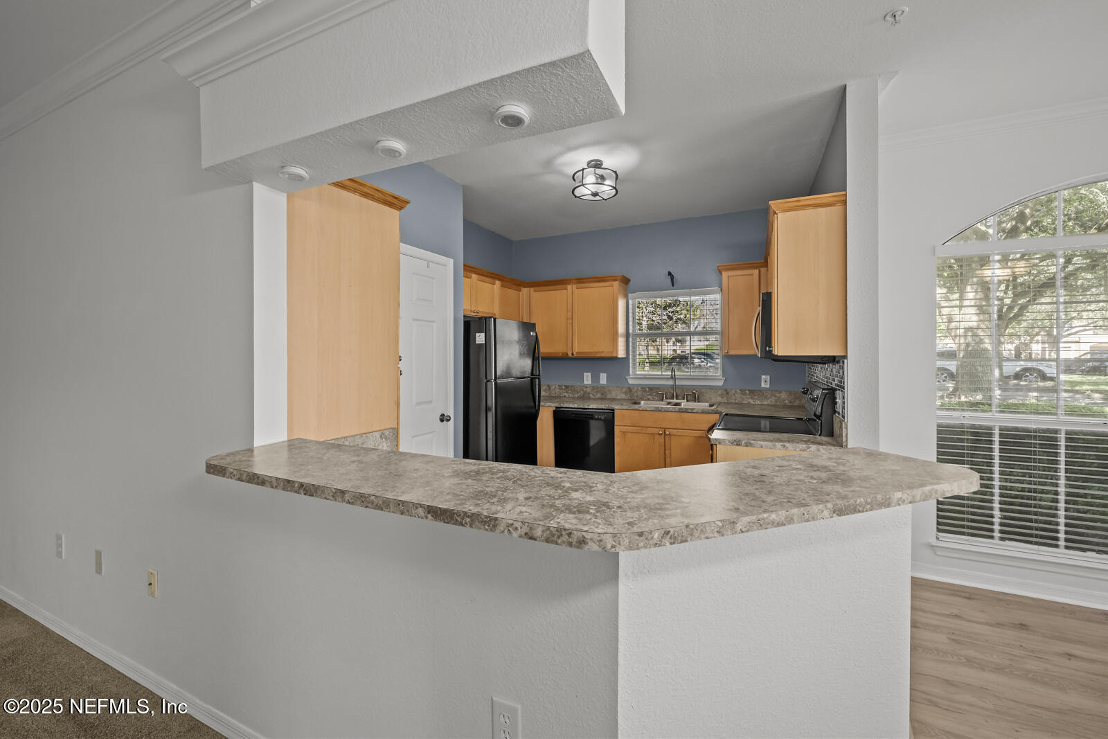10961 Burnt Mill Road, Unit 1217 Jacksonville, FL 32256 - Photo 3 of 59 a kitchen with stainless steel appliances granite countertop a sink a stove and a wooden floors