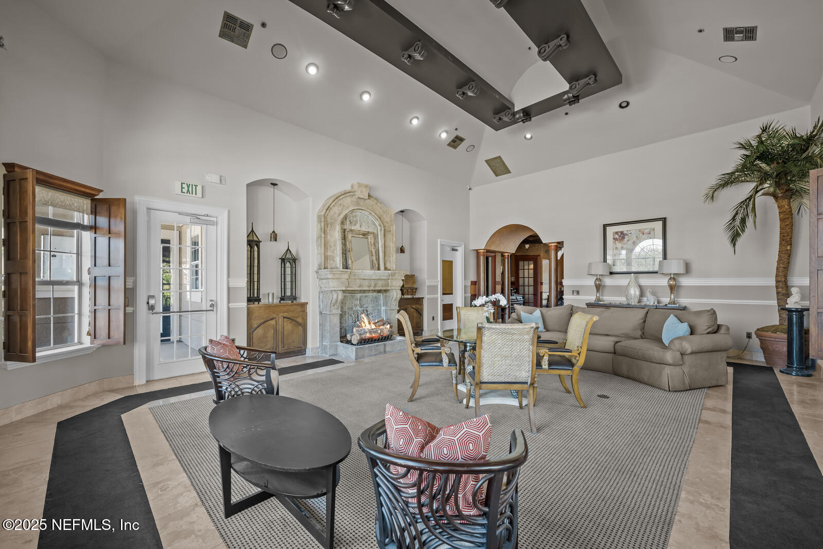 10961 Burnt Mill Road, Unit 1217 Jacksonville, FL 32256 - Photo 34 of 59 a living room with furniture a chandelier and a dining table with wooden floor