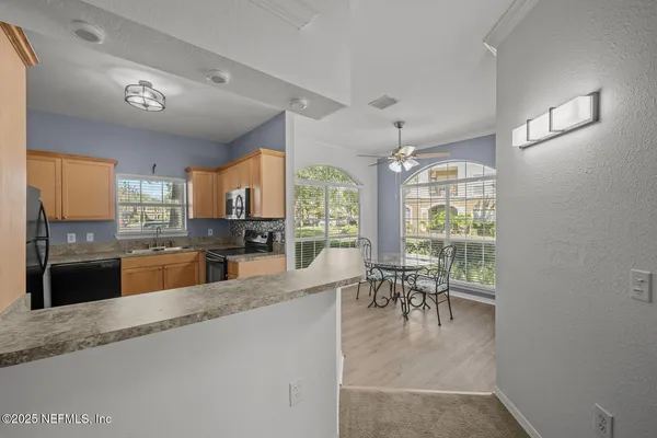 a kitchen with a refrigerator sink and stove