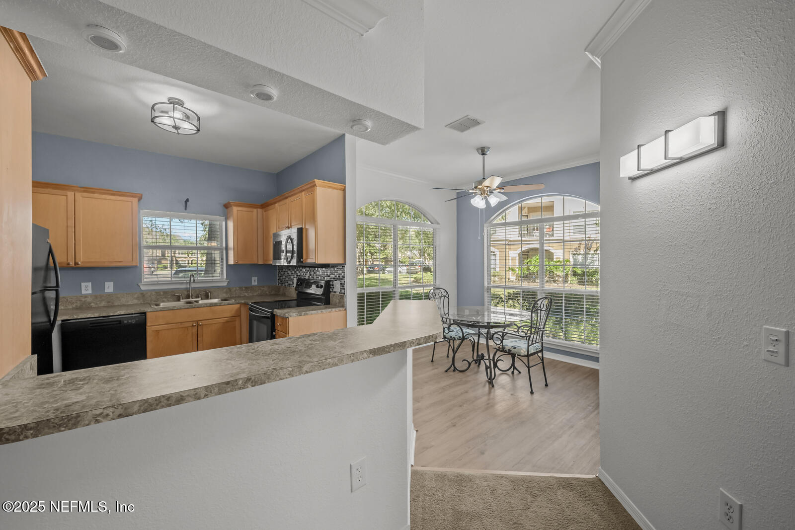 10961 Burnt Mill Road, Unit 1217 Jacksonville, FL 32256 - Photo 4 of 59 a large white kitchen with lots of counter space and breakfast area