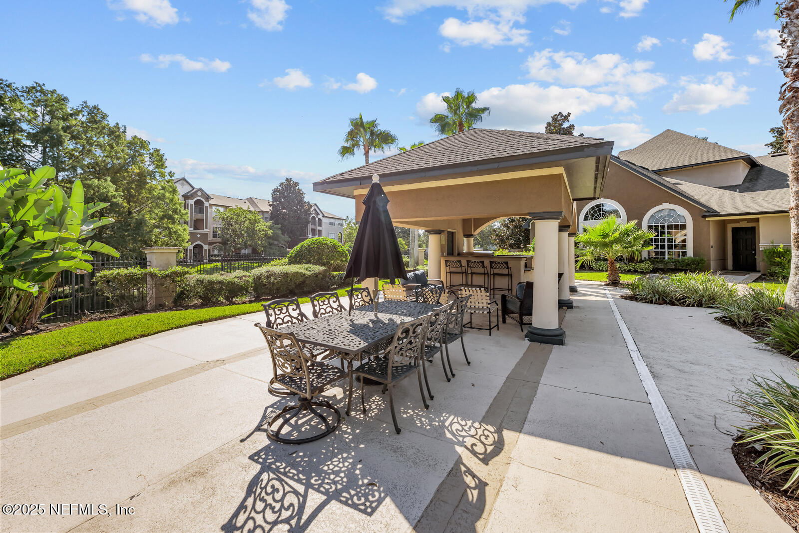 10961 Burnt Mill Road, Unit 1217 Jacksonville, FL 32256 - Photo 47 of 59 a view of a patio with table and chairs and potted plants