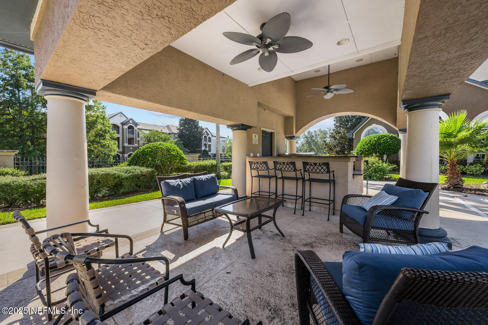10961 Burnt Mill Road, Unit 1217 Jacksonville, FL 32256 - Photo 48 of 59 a outdoor space with patio the couches and a dining table with garden view