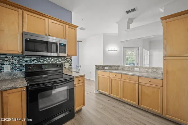 a kitchen with a stove a sink and a microwave