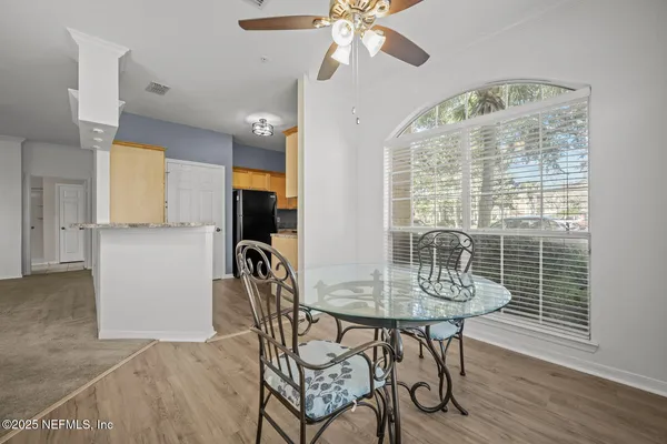 a view of a dining room with furniture window and wooden floor