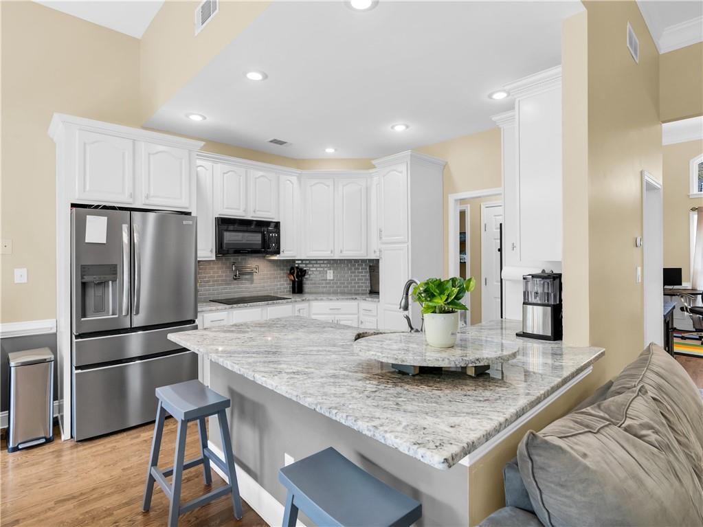 157 Cooks Way McDonough, GA 30252 - Photo 15 of 63 a kitchen with kitchen island a counter top space a sink stainless steel appliances and cabinets