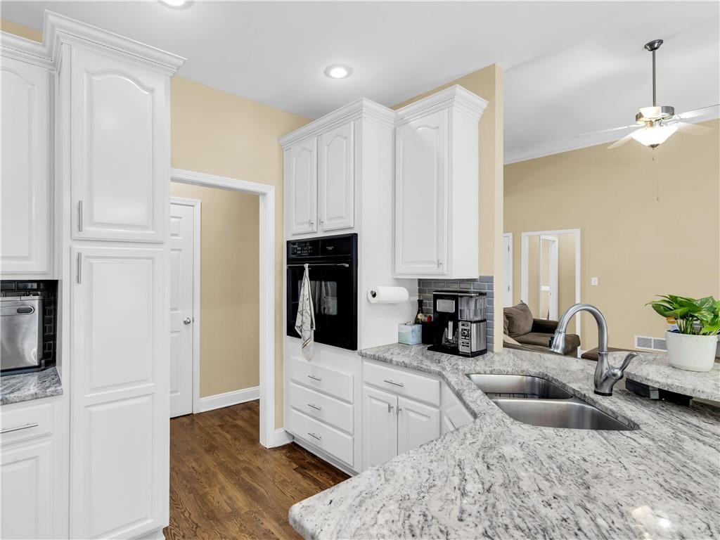 157 Cooks Way McDonough, GA 30252 - Photo 16 of 63 a kitchen with granite countertop a sink a stove and a refrigerator