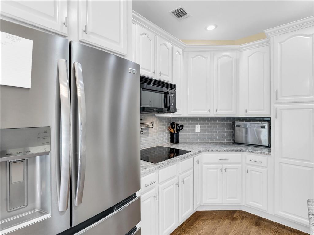 157 Cooks Way McDonough, GA 30252 - Photo 17 of 63 a kitchen with granite countertop white cabinets and refrigerator
