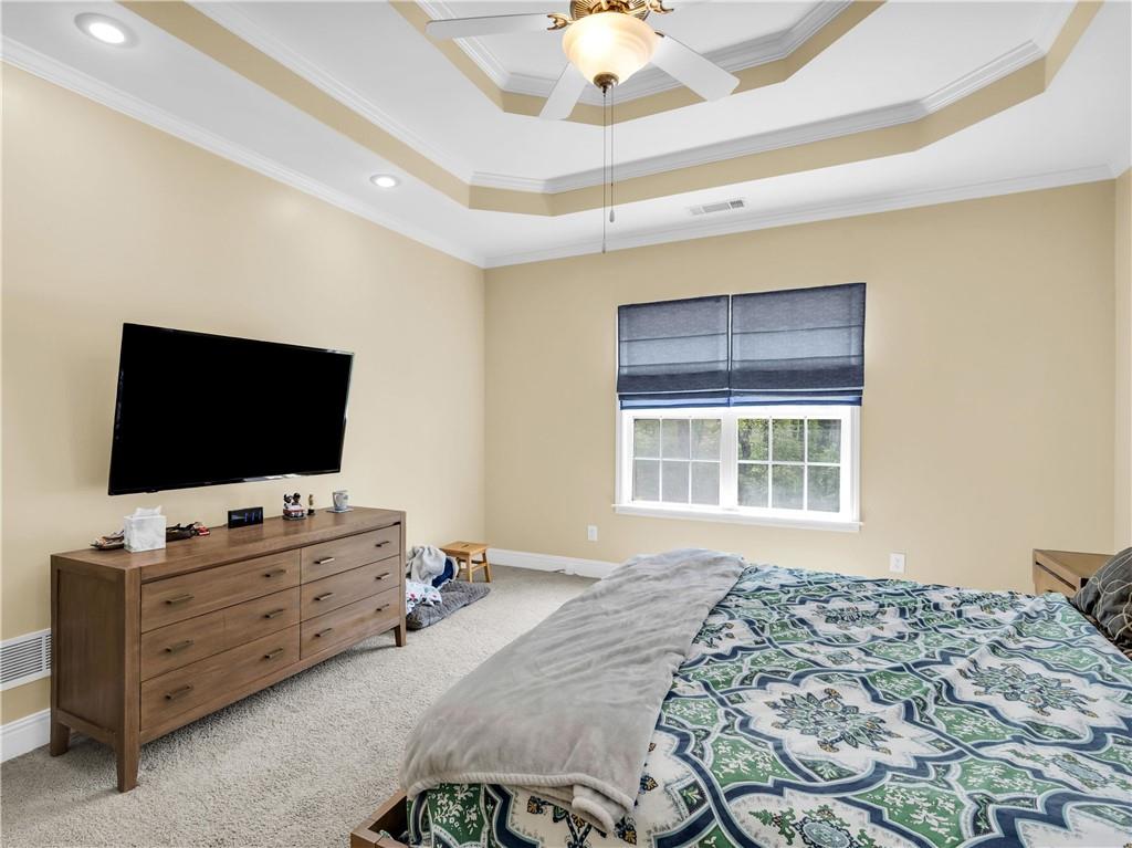 157 Cooks Way McDonough, GA 30252 - Photo 22 of 63 a bedroom with a bed and flat screen tv