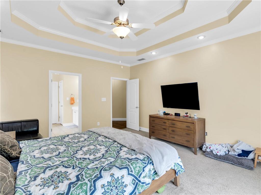 157 Cooks Way McDonough, GA 30252 - Photo 23 of 63 a bedroom with a bed and a flat screen tv