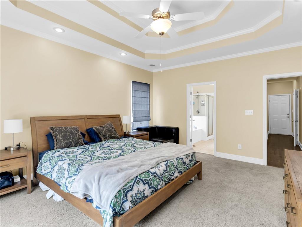 157 Cooks Way McDonough, GA 30252 - Photo 24 of 63 a bedroom with a bed and a chandelier