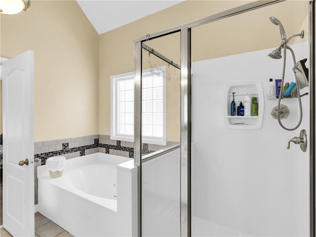 157 Cooks Way McDonough, GA 30252 - Photo 26 of 63 a bathroom with a bathtub and a shower